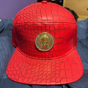 Mens’ red leather hat with flashy medallion!
